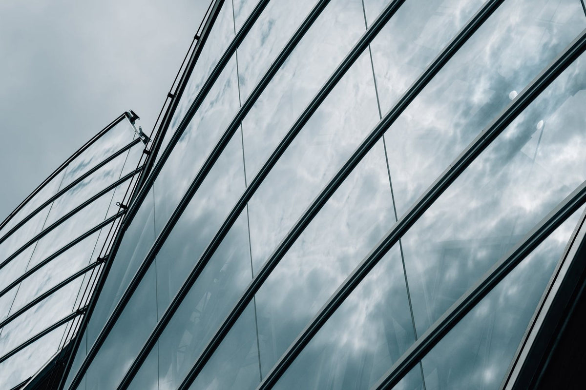 Reflective glass building reflecting clouds